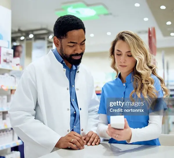 Pharmacist speaking with pharmacy technician